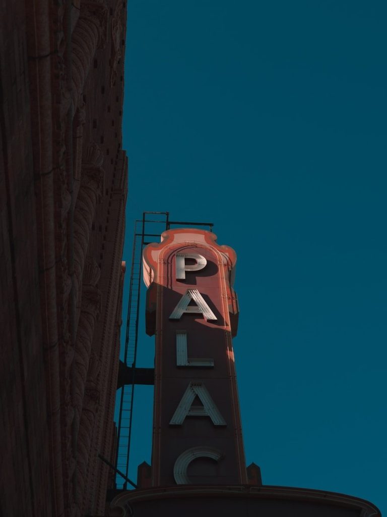 Palace theater sign against a clear blue sky